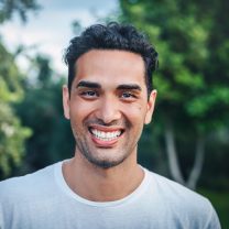 Portrait of a beautiful smiling young man at the park